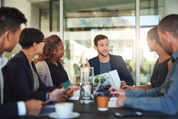 Business team discussing change management in digital transformation during a collaborative meeting in a modern office.